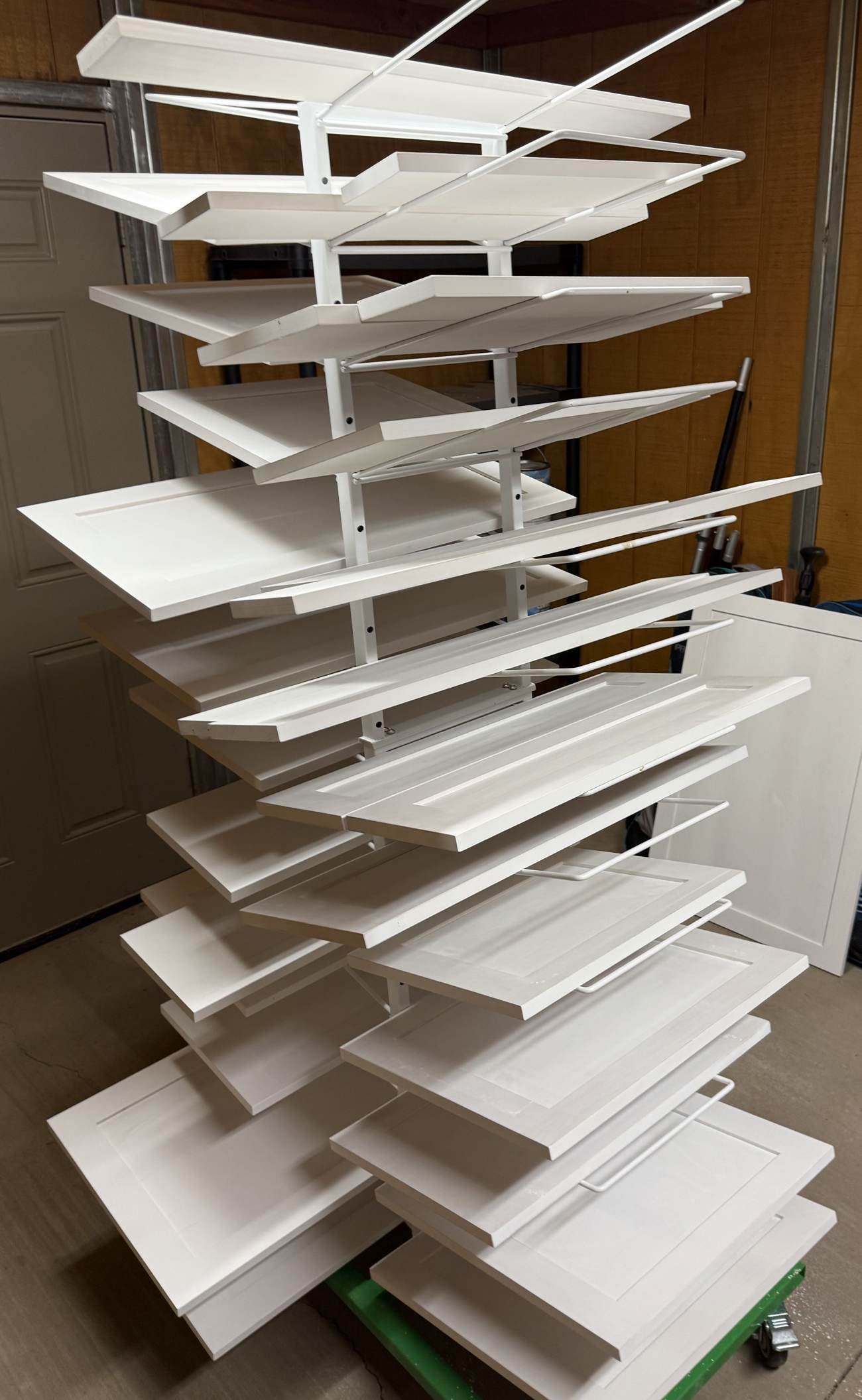 Freshly painted cabinet doors curing on a drying rack
