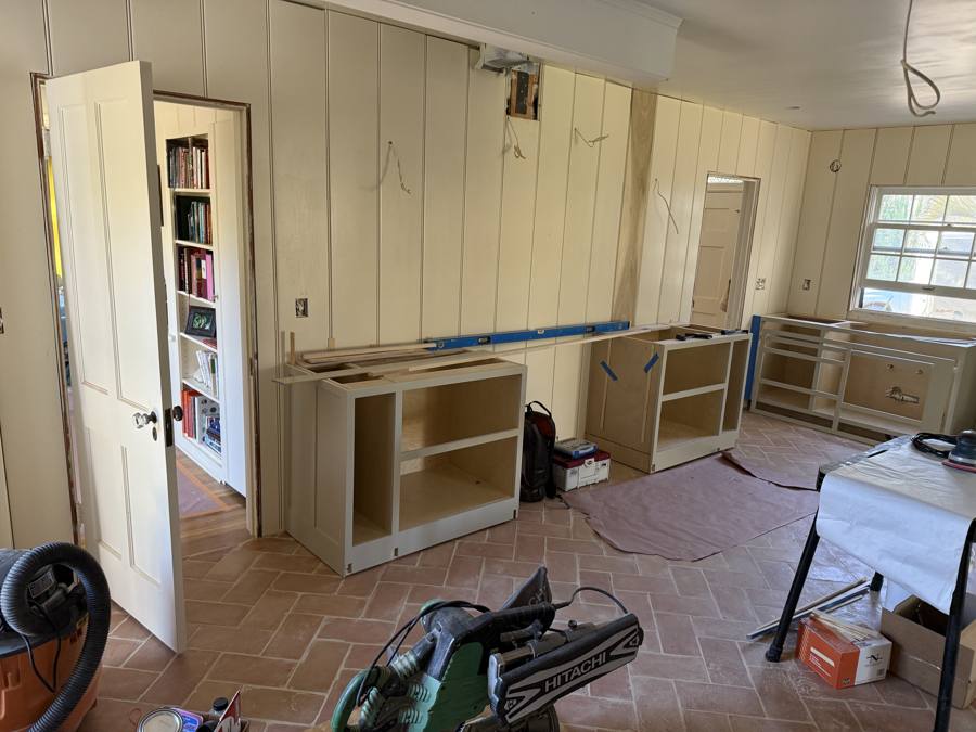 Custom cabinets being installed in the same home